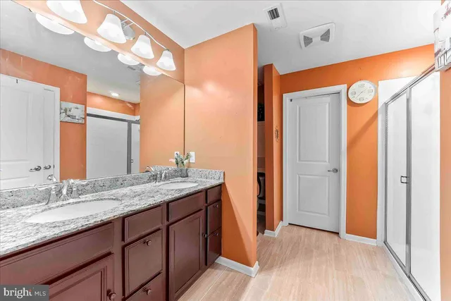 a spacious bedroom with a bed and a chandelier