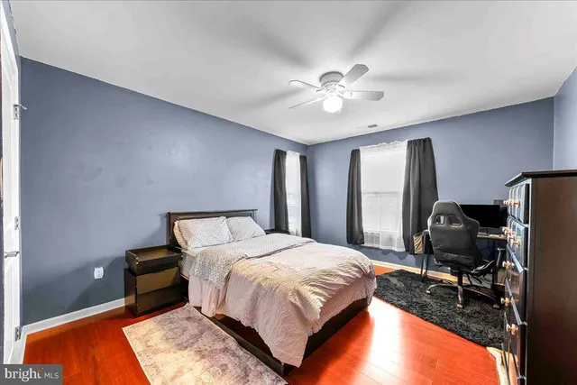 a bedroom with a bed dresser and a window