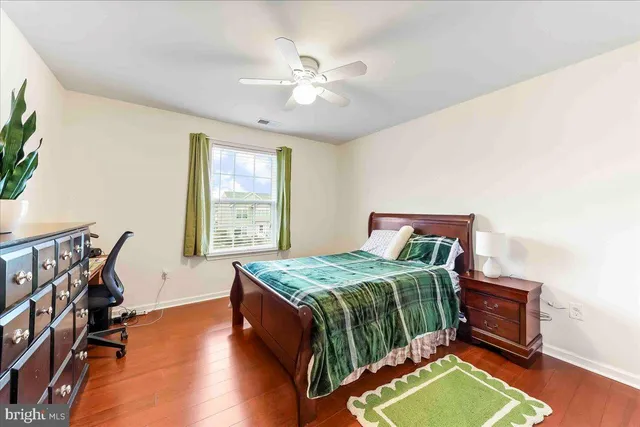 a bathroom with a granite countertop toilet sink and mirror