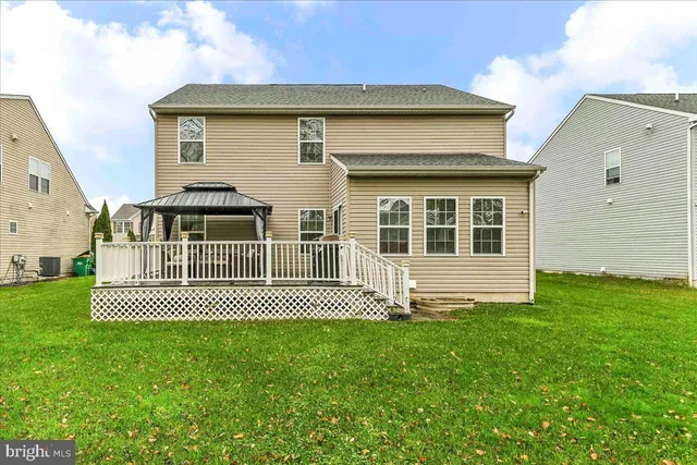 a view of a house with a wooden deck