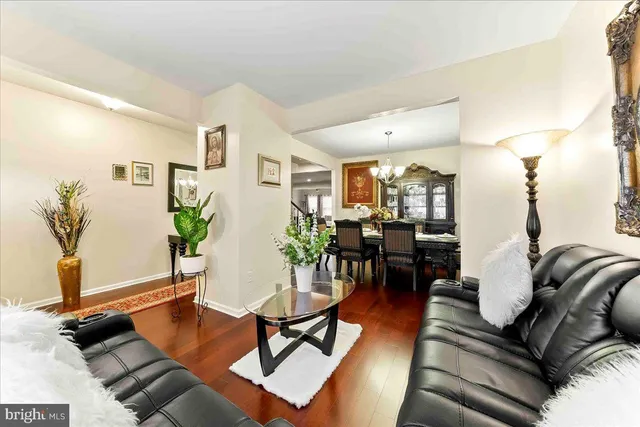 a view of a dining room with furniture wooden floor and chandelier