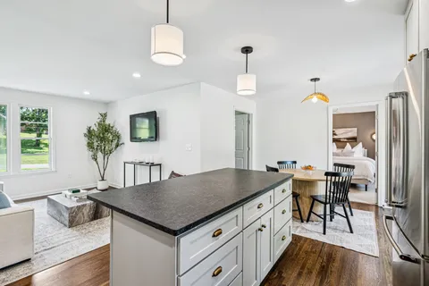 a view of kitchen island with furniture and wooden floor