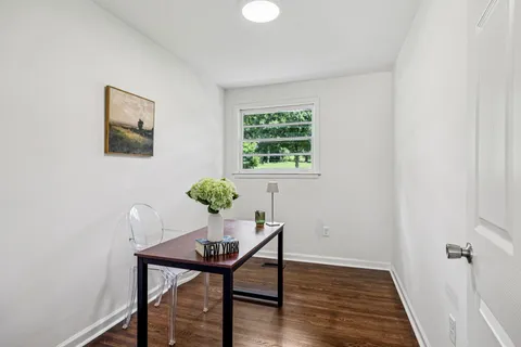 a view of a room with furniture and wooden floor