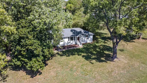 a view of house with a tree in the background