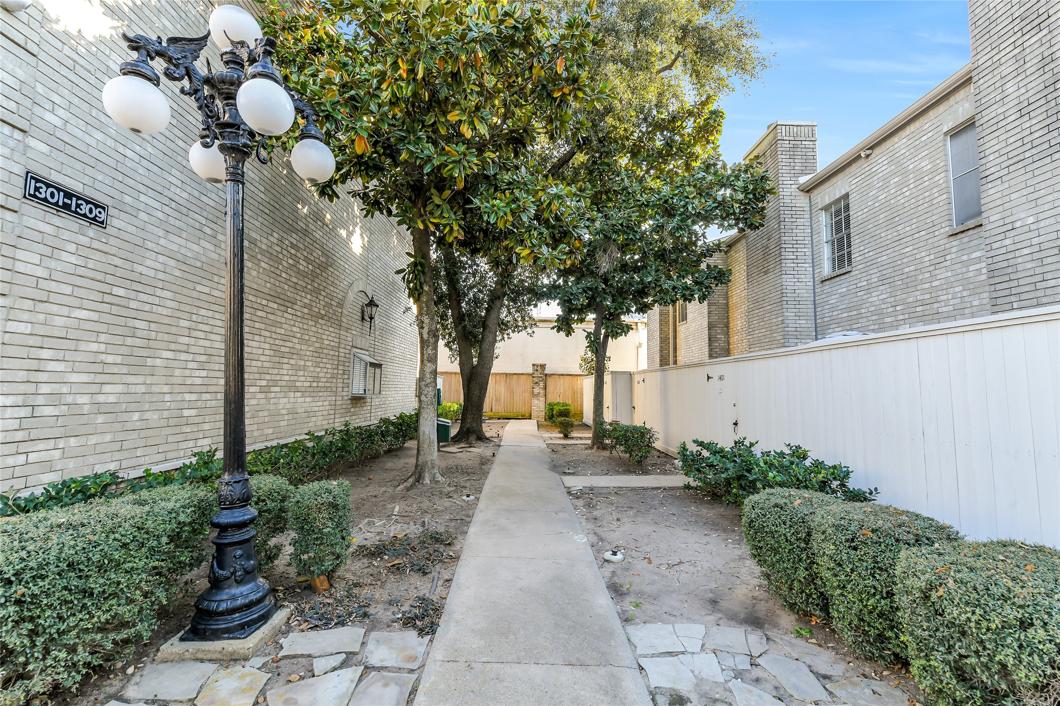 4001 Tanglewilde Street, Unit 1402 Houston, TX 77063 - Photo 22 of 23 Discover the charm of these well-maintained townhomes featuring lighted walkways, mature trees, new fencing, two-car garages, and cozy fireplaces, all conveniently located minutes from major routes like the Westpark Tollway and Sam Houston Tollway for seamless city access.