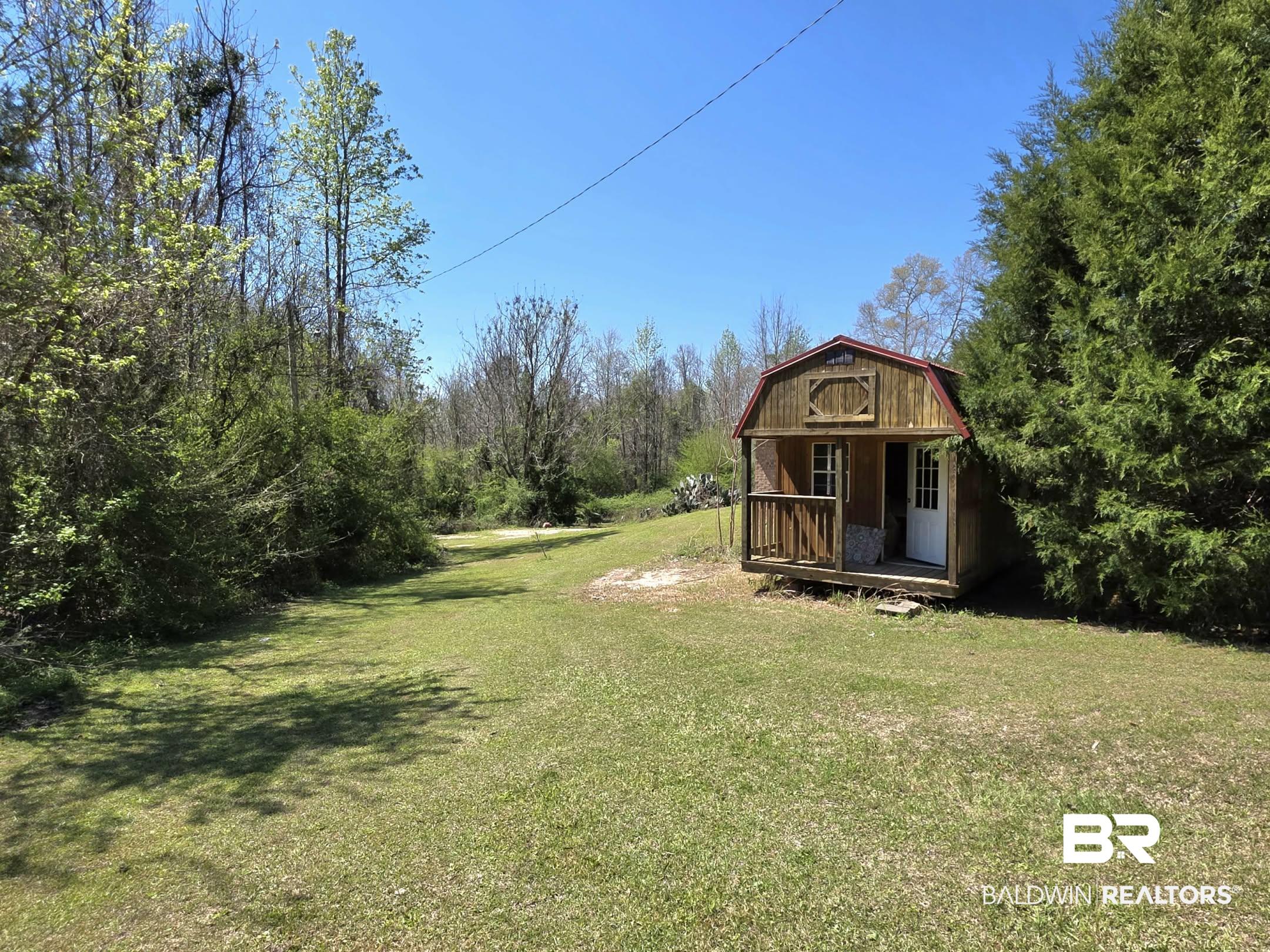 11 Coal Fire Road Jackson, AL 36545 - Photo 12 of 23 View of grassy yard featuring an outdoor structure