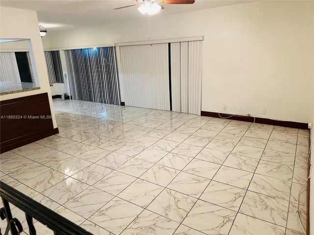 a view of a livingroom with an empty space and a window