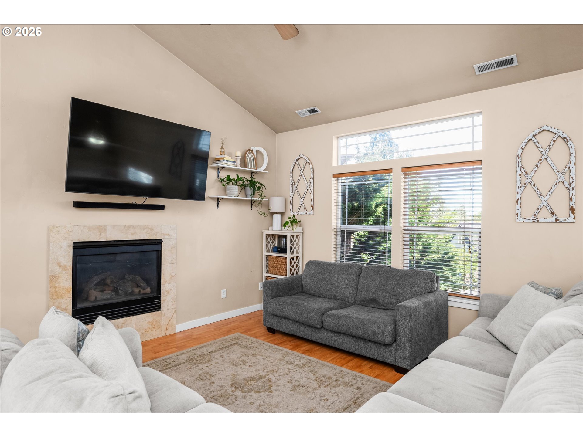 277 South 67th Court Springfield, OR 97478 - Photo 6 of 44 a living room with furniture a flat screen tv and a fireplace
