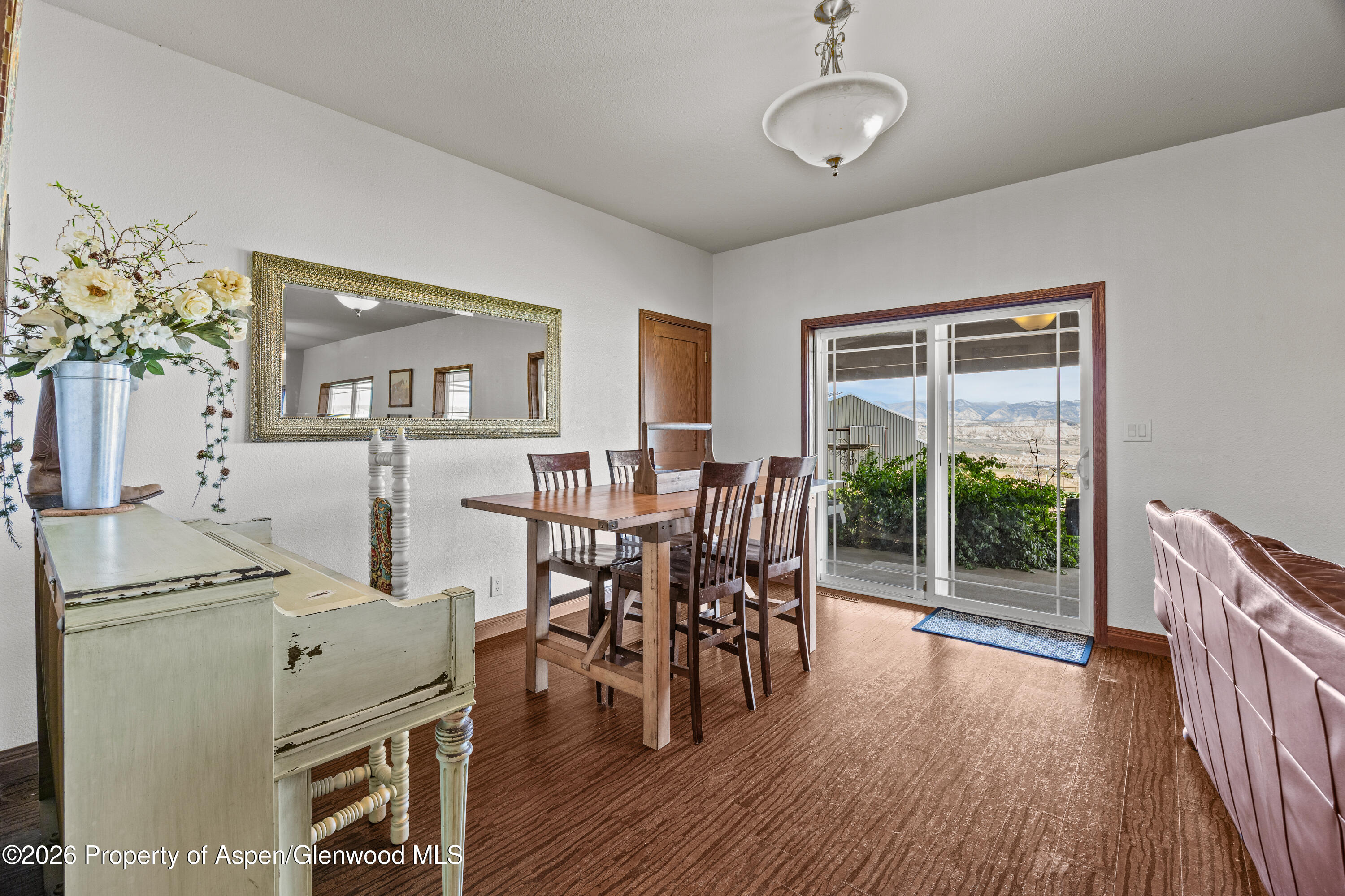 8877 County Road 320 Rifle, CO 81650 - Photo 36 of 51 a view of a dining room with furniture window and wooden floor