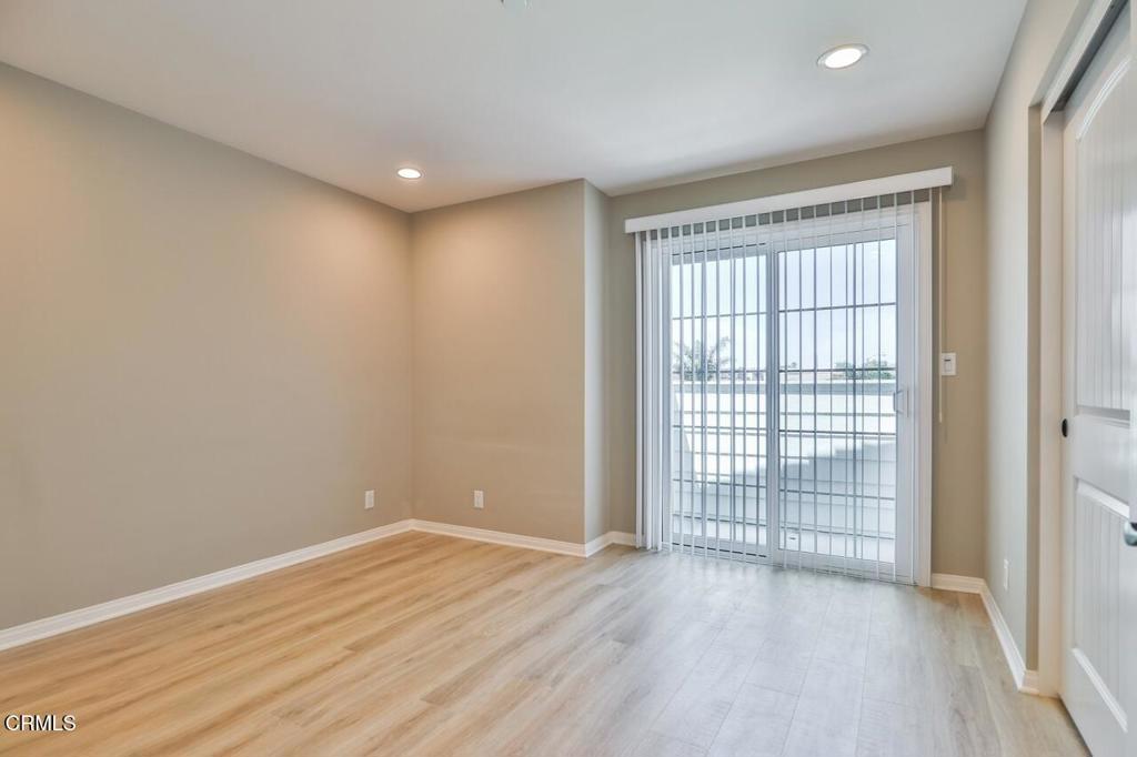 1030 Canal Street Oxnard, CA 93035 - Photo 13 of 26 a view of an empty room with wooden floor and a window