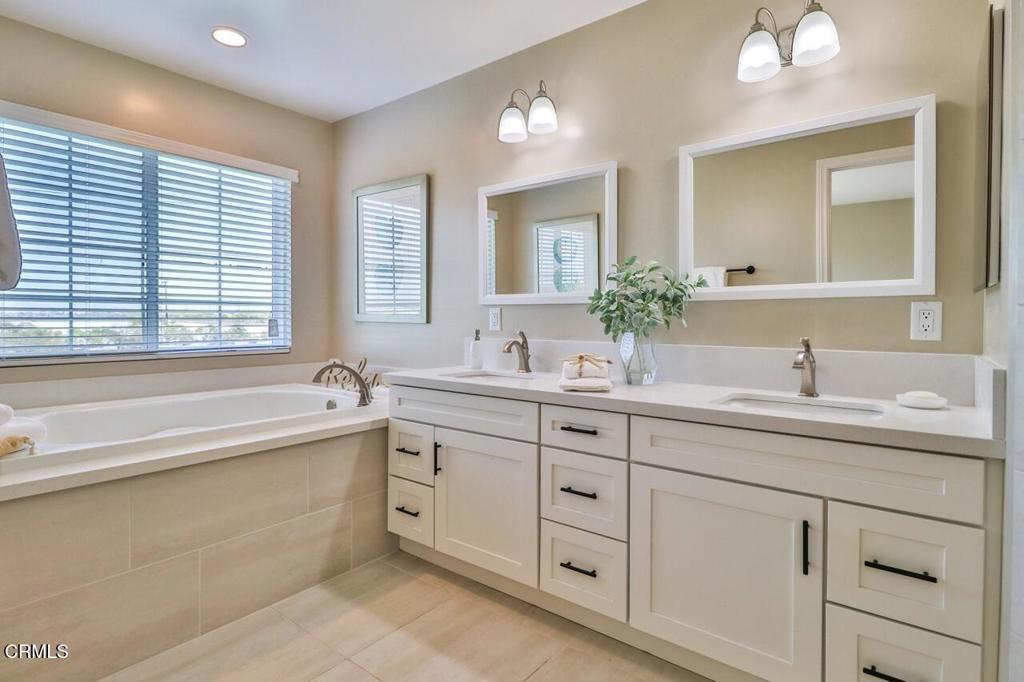 1030 Canal Street Oxnard, CA 93035 - Photo 16 of 26 a bathroom with a granite countertop sink mirror and bathtub