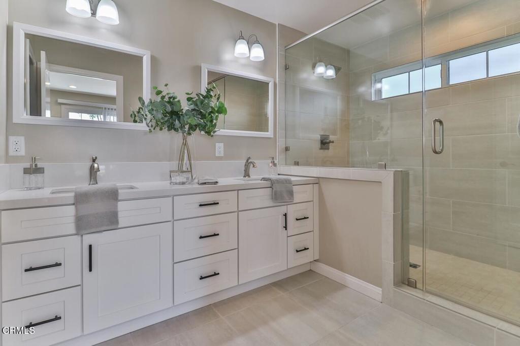 1030 Canal Street Oxnard, CA 93035 - Photo 7 of 26 a bathroom with a double vanity sink mirror and shower