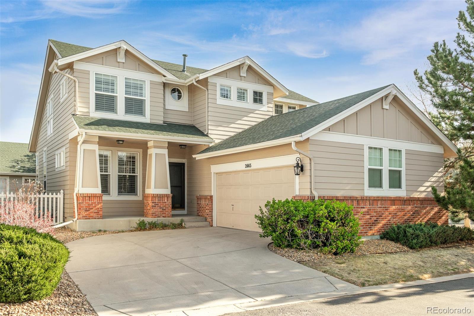 2665 South Troy Court Aurora, CO 80014 - Photo 1 of 29 a front view of a house with a yard and potted plants