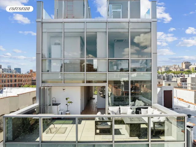 a view of a workspace with furniture and window