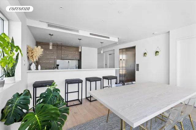 a kitchen with stainless steel appliances granite countertop a sink a stove and a wooden floors