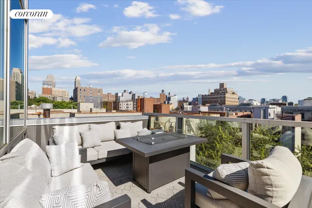 a living room with kitchen island furniture and a potted plant