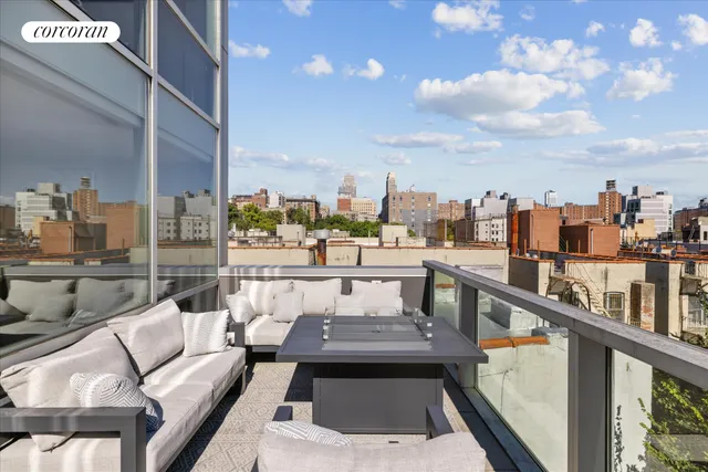 a terrace with outdoor seating and city view