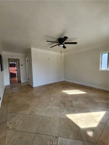 a view of a livingroom with a ceiling fan and window