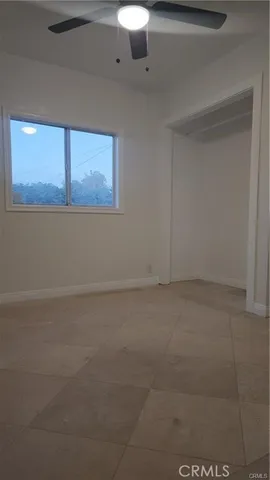 a view of a small space with wooden floor and windows