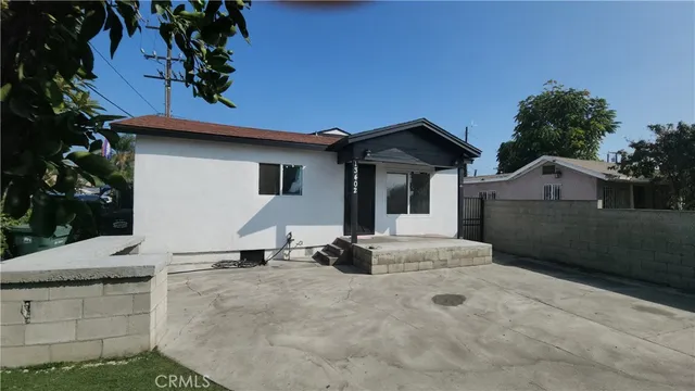 a backyard of a house with table and chairs