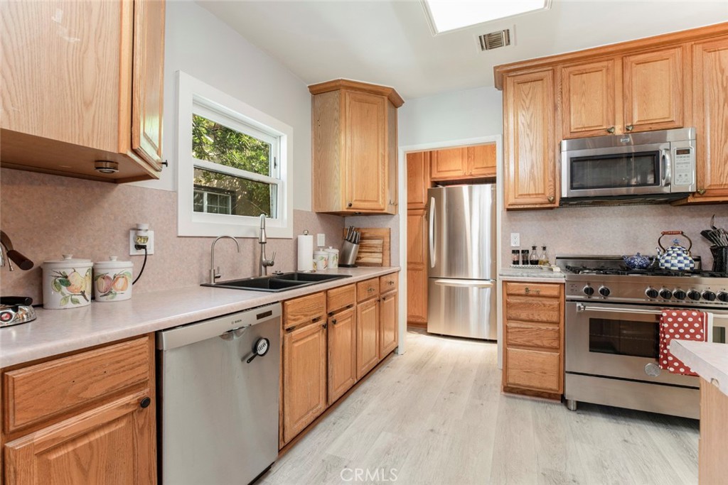 1748 Bel Aire Drive Glendale, CA 91201 - Photo 13 of 51 a kitchen with stainless steel appliances granite countertop a refrigerator stove and sink