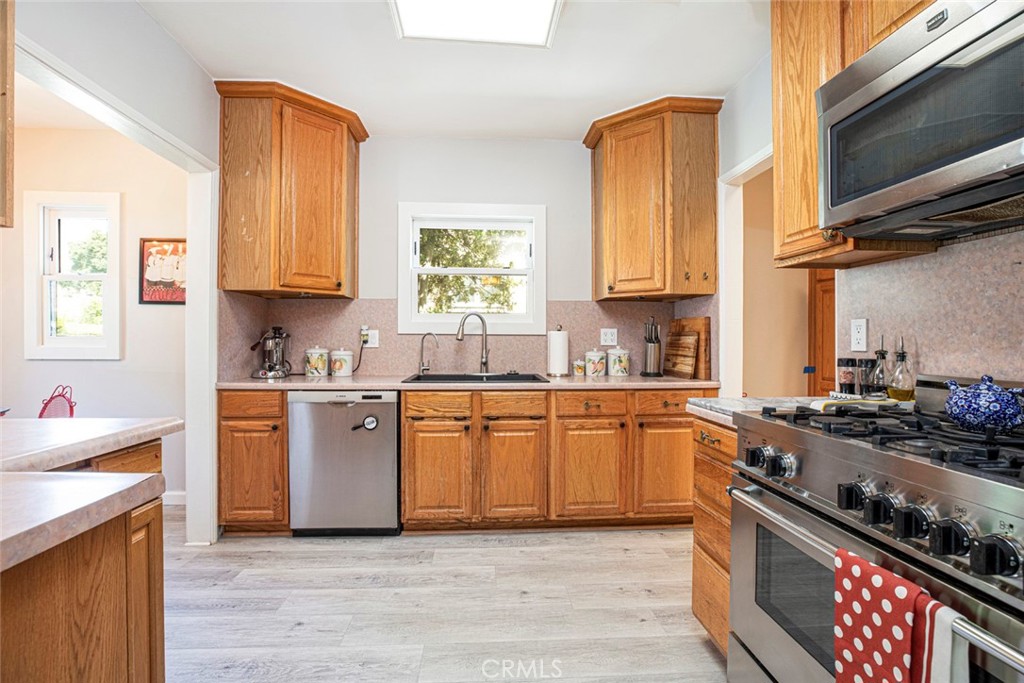 1748 Bel Aire Drive Glendale, CA 91201 - Photo 14 of 51 a kitchen with stainless steel appliances granite countertop a stove a sink and a microwave