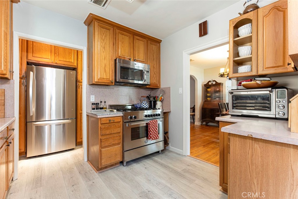 1748 Bel Aire Drive Glendale, CA 91201 - Photo 15 of 51 a kitchen with stainless steel appliances a refrigerator stove and microwave