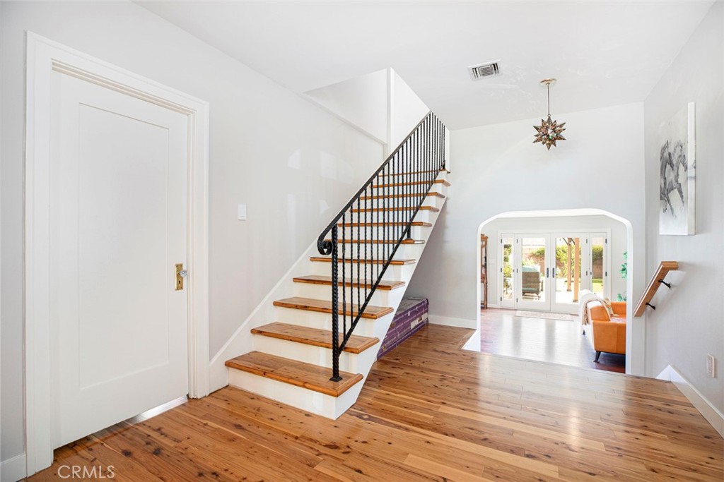 1748 Bel Aire Drive Glendale, CA 91201 - Photo 18 of 51 a view of a bedroom with wooden floor and stairs