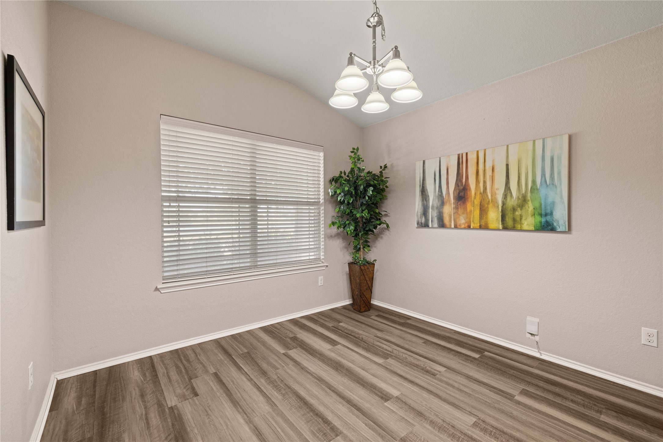 20105 Harrier Flight Trail Pflugerville, TX 78660 - Photo 10 of 35 Spare room featuring lofted ceiling, suspended lighting, and light wood-style flooring