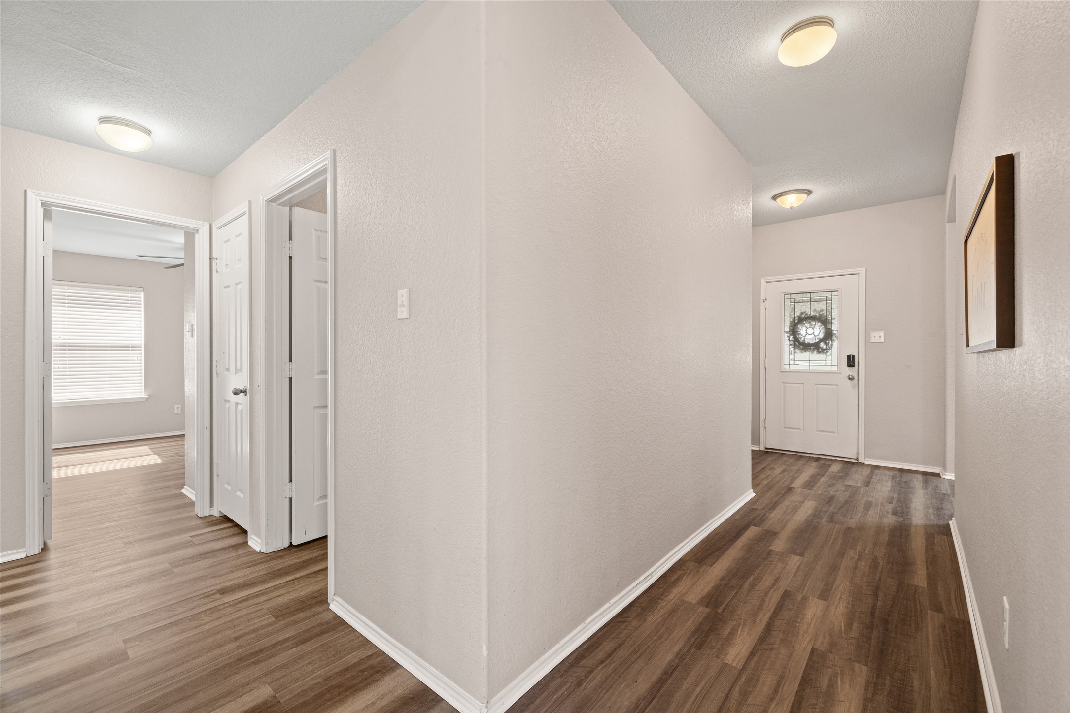 20105 Harrier Flight Trail Pflugerville, TX 78660 - Photo 11 of 35 Hall with dark wood finished floors and a textured wall