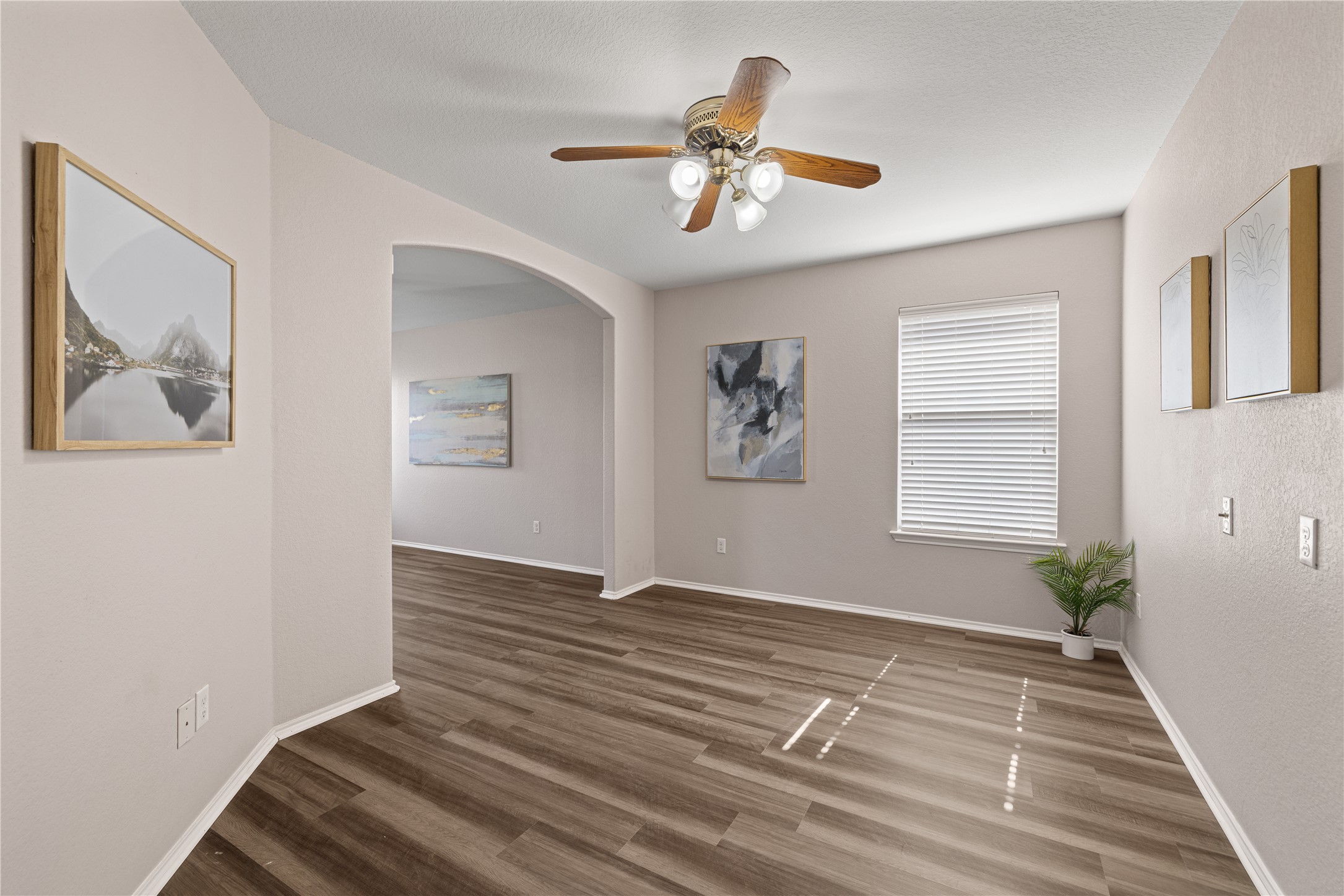 20105 Harrier Flight Trail Pflugerville, TX 78660 - Photo 12 of 35 Additional flex space in primary bedroom with a ceiling fan, wood finished floors, and arched walkways