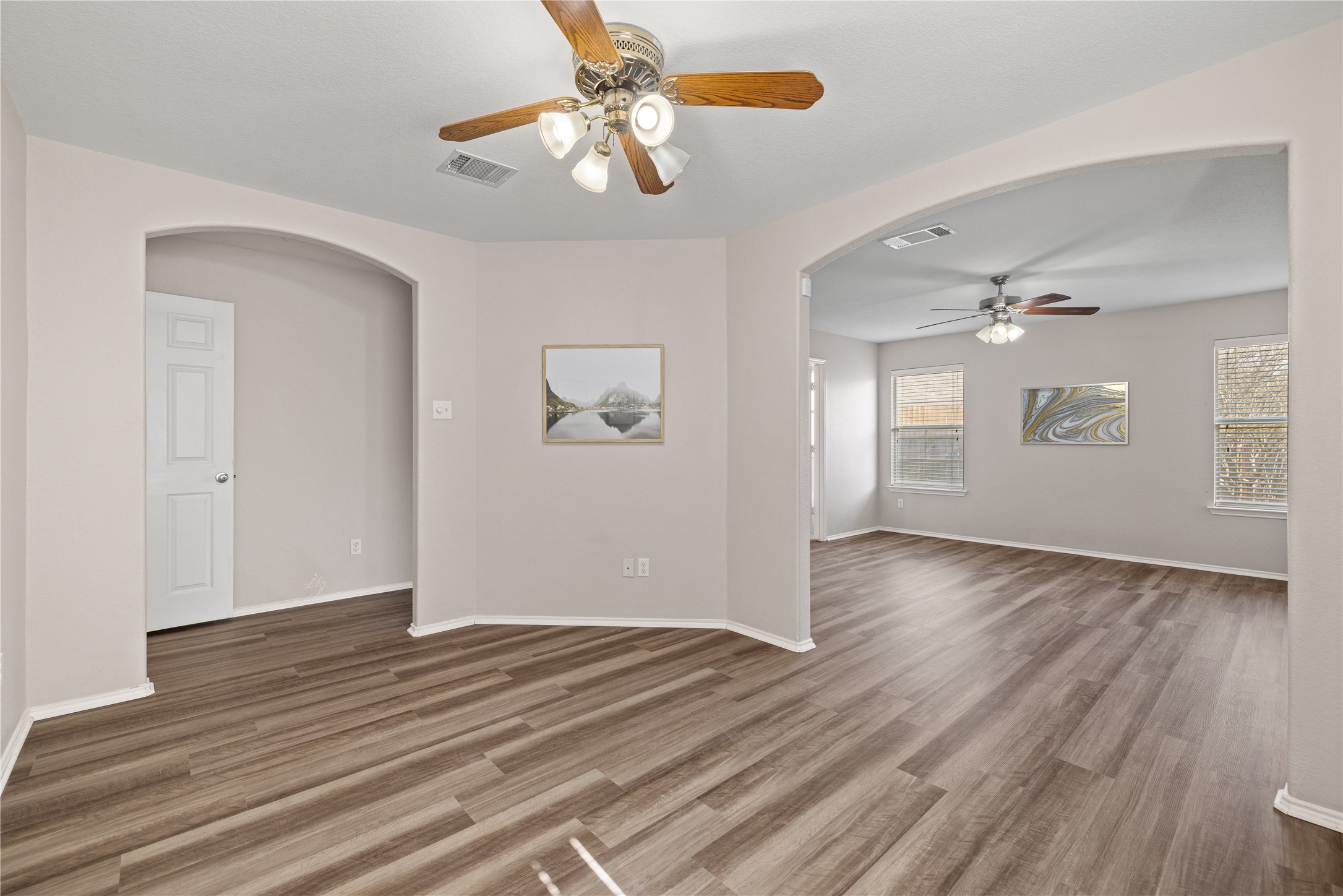 20105 Harrier Flight Trail Pflugerville, TX 78660 - Photo 13 of 35 Additional flex space in primary bedroom with a ceiling fan, wood finished floors, and arched walkways