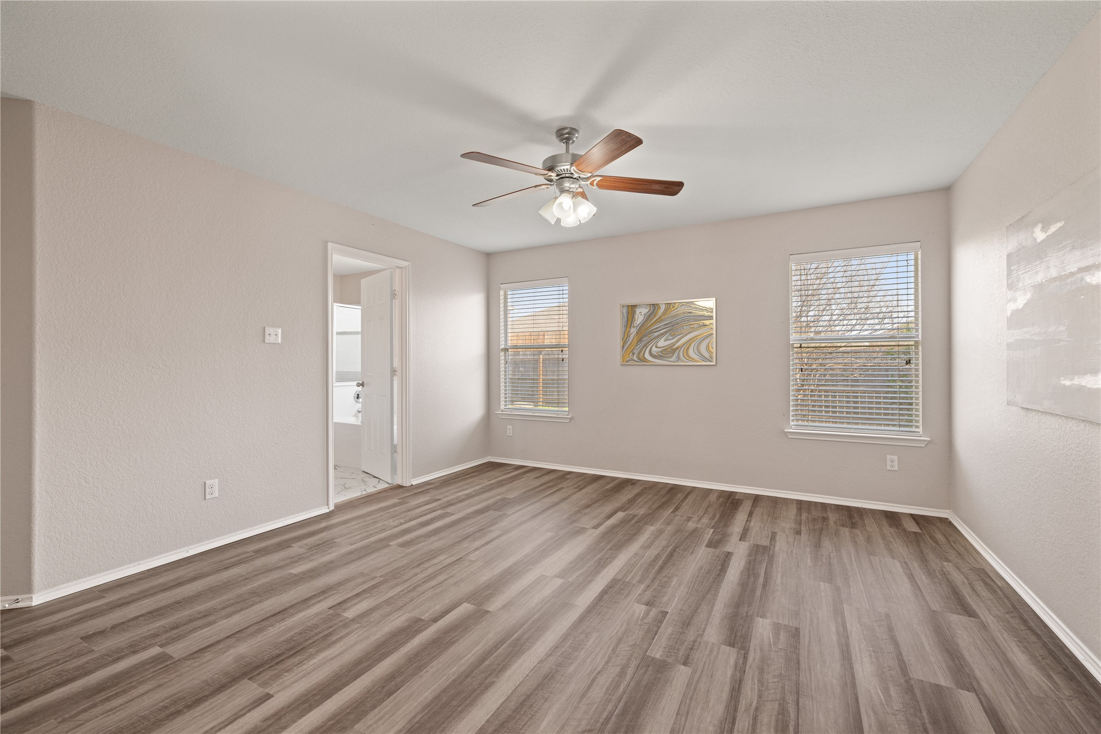 20105 Harrier Flight Trail Pflugerville, TX 78660 - Photo 14 of 35 Primary bedroom room featuring light wood-type flooring, a ceiling fan, and healthy amount of natural light
