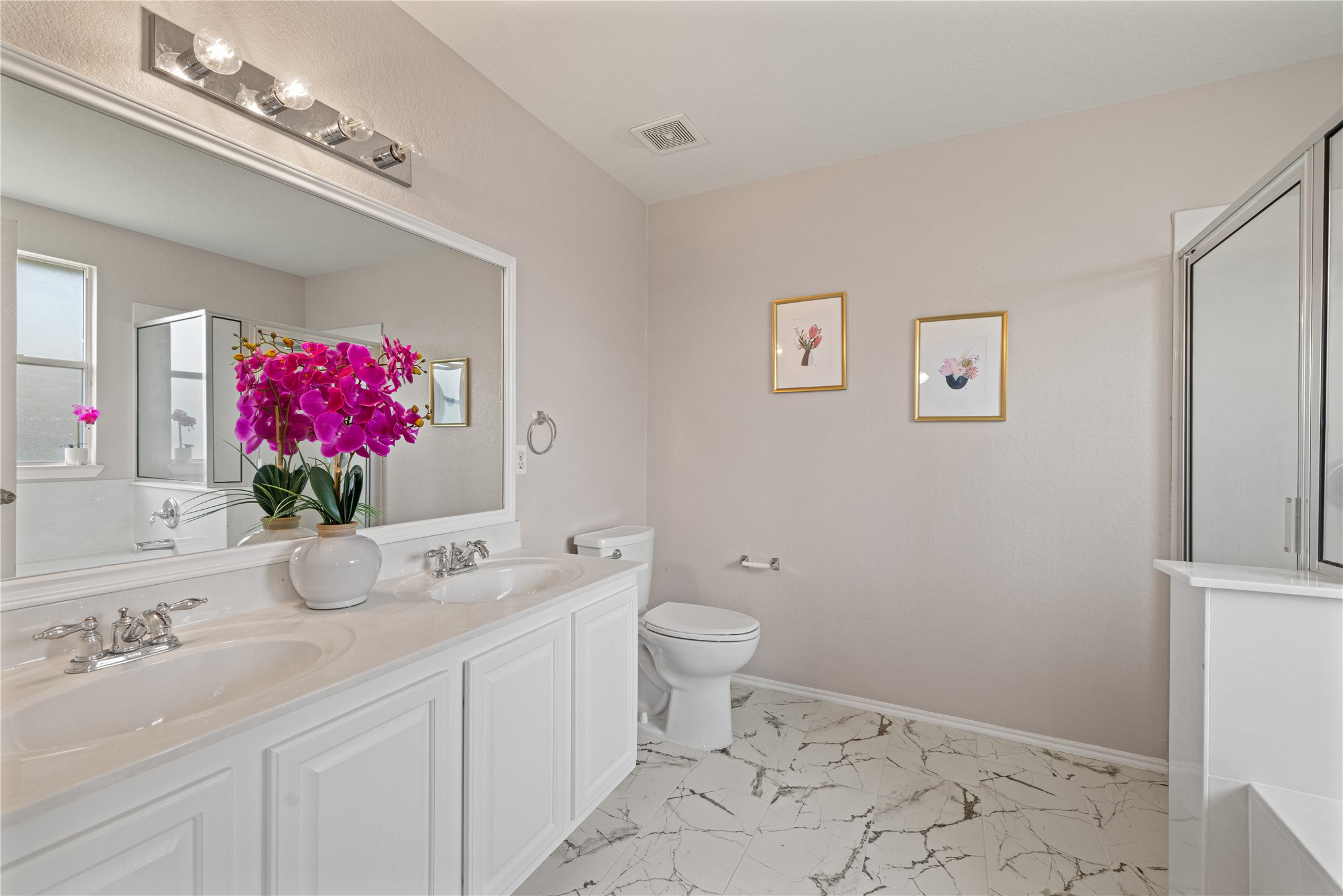 20105 Harrier Flight Trail Pflugerville, TX 78660 - Photo 15 of 35 Full bathroom featuring a stall shower, double vanity, a tub to relax in, and light marble finish flooring