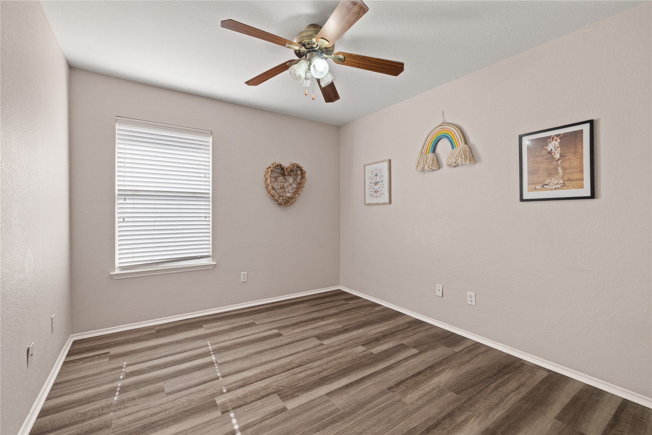 20105 Harrier Flight Trail Pflugerville, TX 78660 - Photo 18 of 35 Bedroom #2 with ceiling fan and wood finished floors