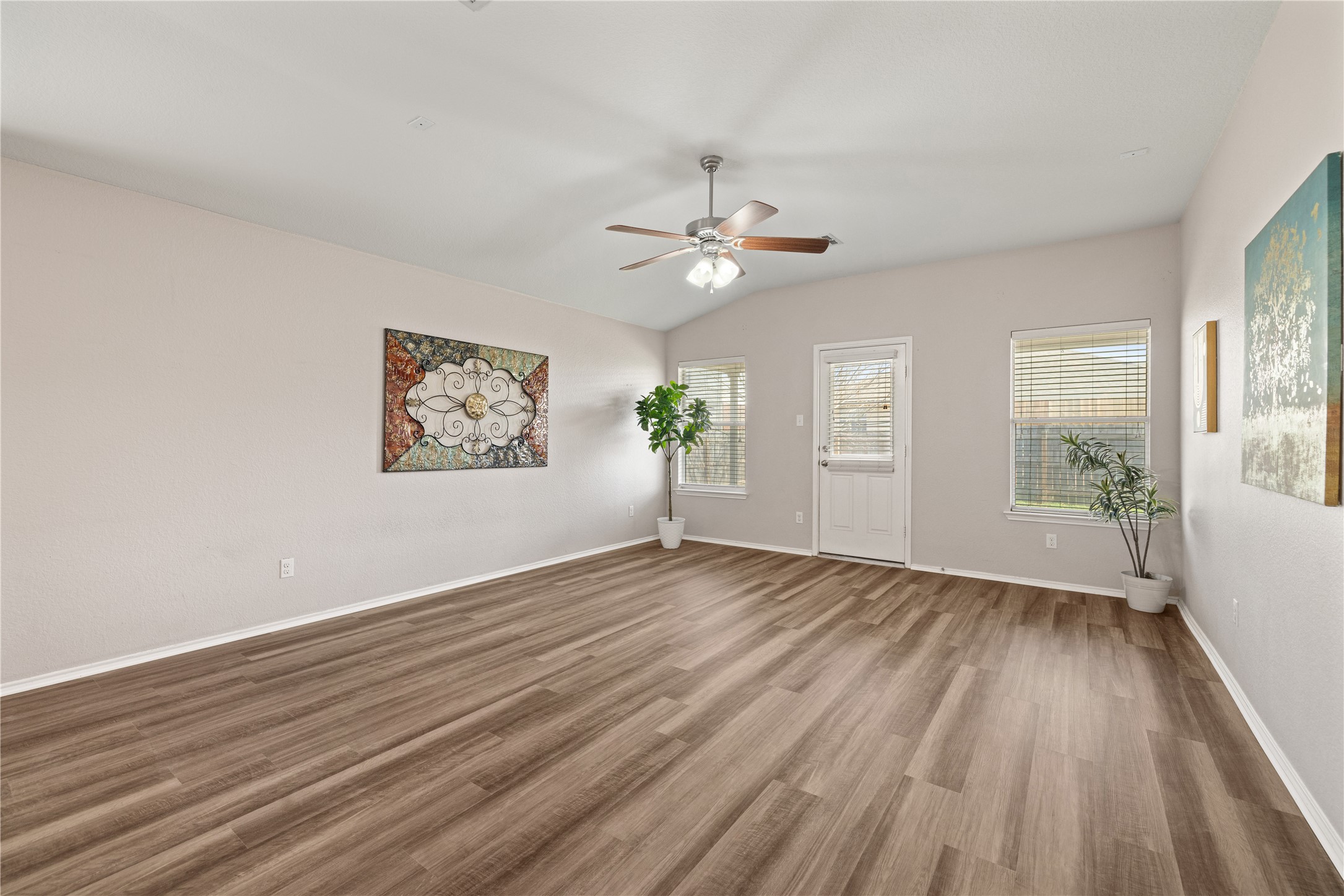 20105 Harrier Flight Trail Pflugerville, TX 78660 - Photo 3 of 35 Empty room with wood finished floors, ceiling fan, and lofted ceiling