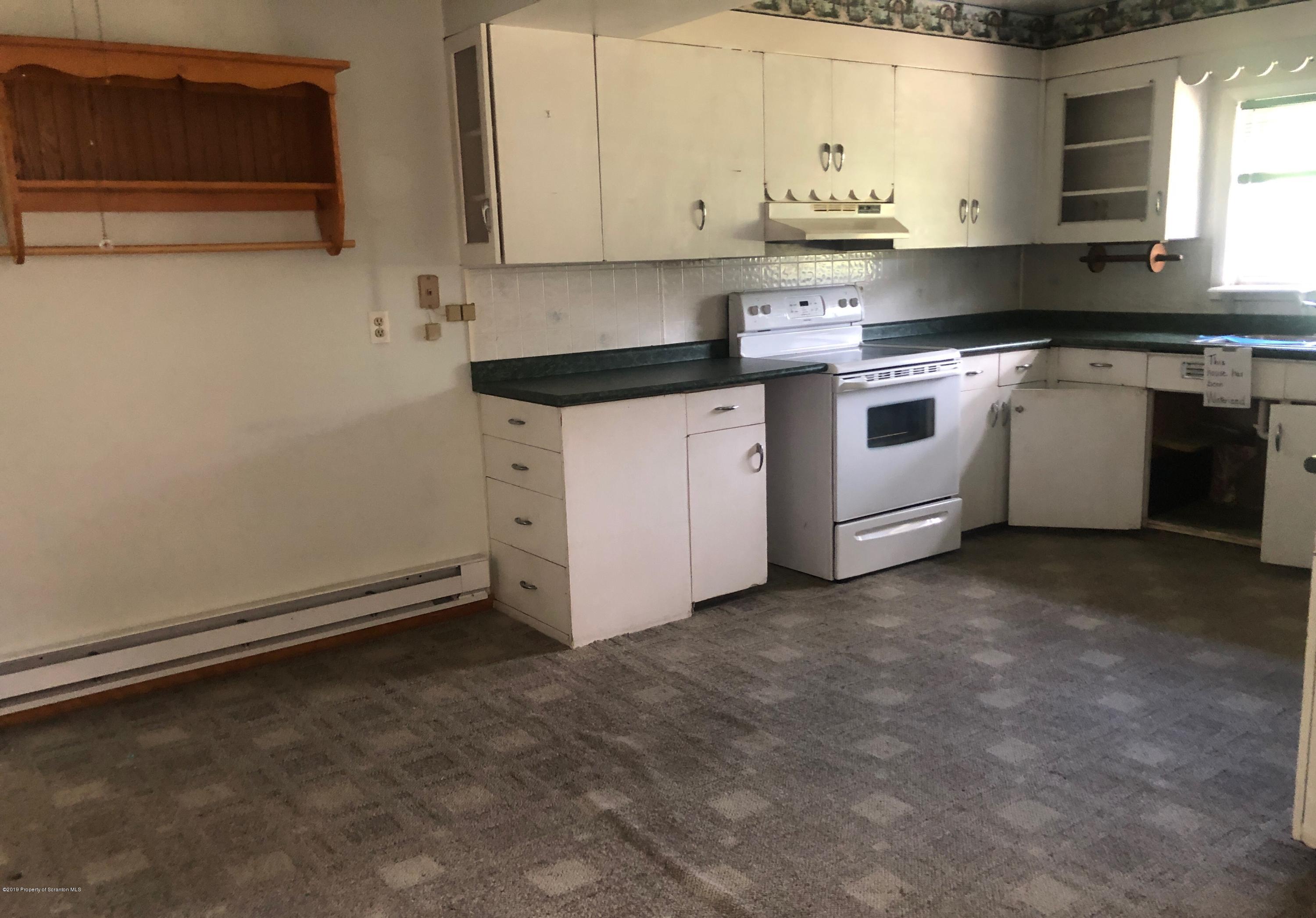621 Randolph Road Great Bend, PA 18821 - Photo 8 of 11 a kitchen with granite countertop white cabinets and white appliances
