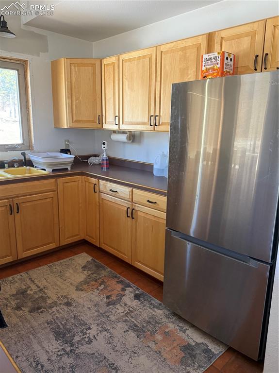 450 Schierl Road Fort Garland, CO 81133 - Photo 27 of 40 a kitchen with stainless steel appliances granite countertop a refrigerator and a sink