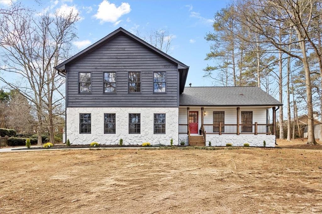 a front view of a house with a yard covered in snow