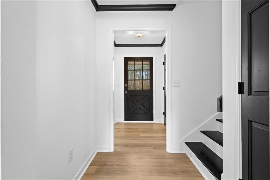 7605 Raleigh Lane Jonesboro, GA 30236 - Photo 12 of 40 a view of a hallway with wooden floor and staircase