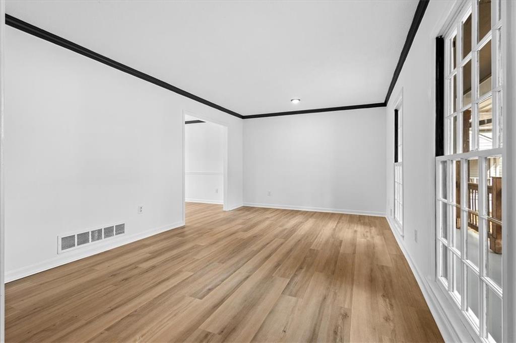7605 Raleigh Lane Jonesboro, GA 30236 - Photo 13 of 40 a view of an empty room with wooden floor and a window
