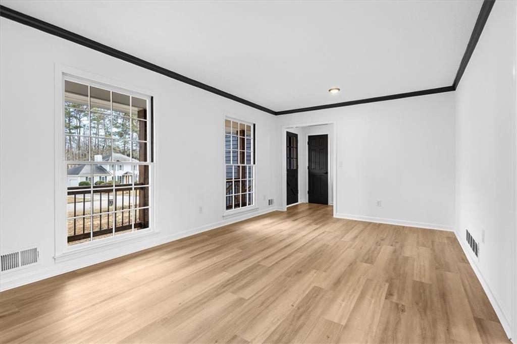 7605 Raleigh Lane Jonesboro, GA 30236 - Photo 14 of 40 a view of an empty room with wooden floor and a window