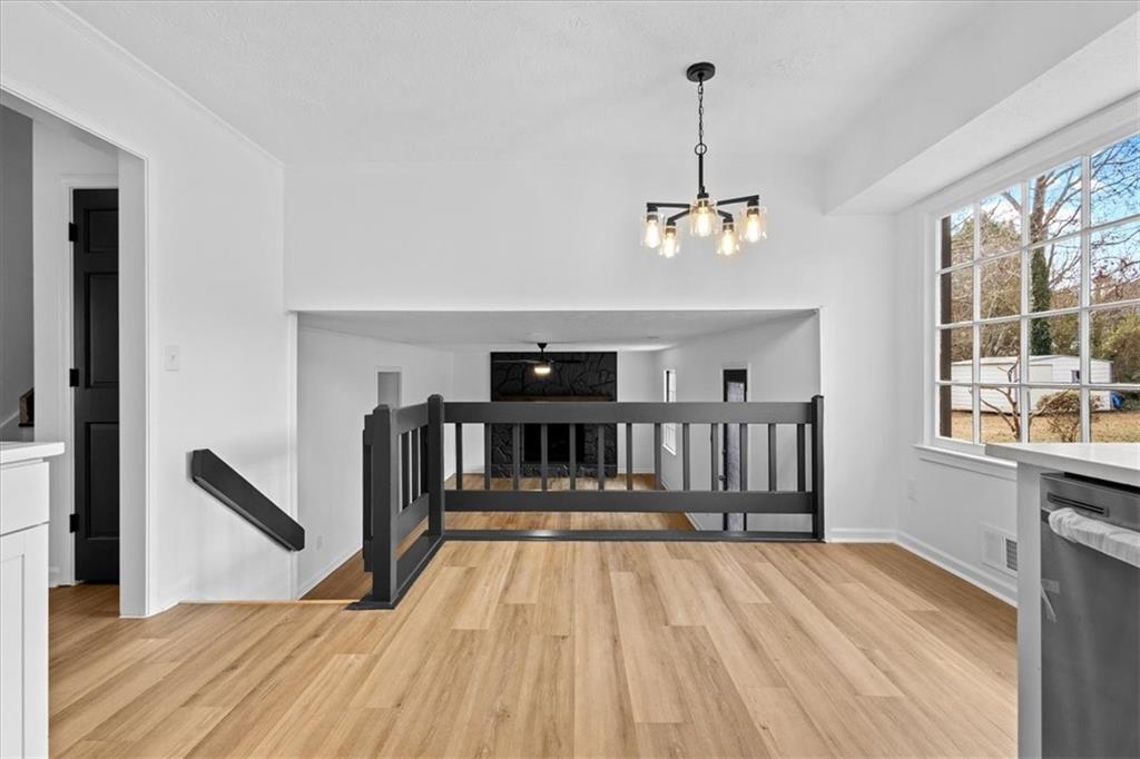 7605 Raleigh Lane Jonesboro, GA 30236 - Photo 18 of 40 a view of wooden floor and a chandelier fan