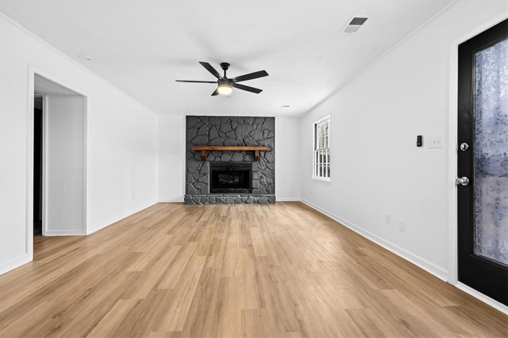 7605 Raleigh Lane Jonesboro, GA 30236 - Photo 21 of 40 a view of empty room with wooden floor and fireplace