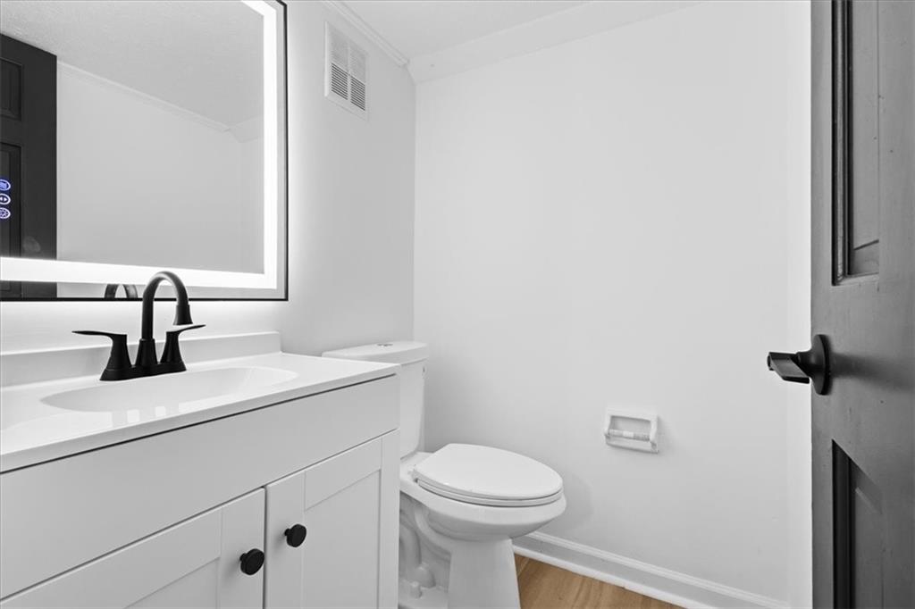 7605 Raleigh Lane Jonesboro, GA 30236 - Photo 24 of 40 a bathroom with a toilet sink and mirror