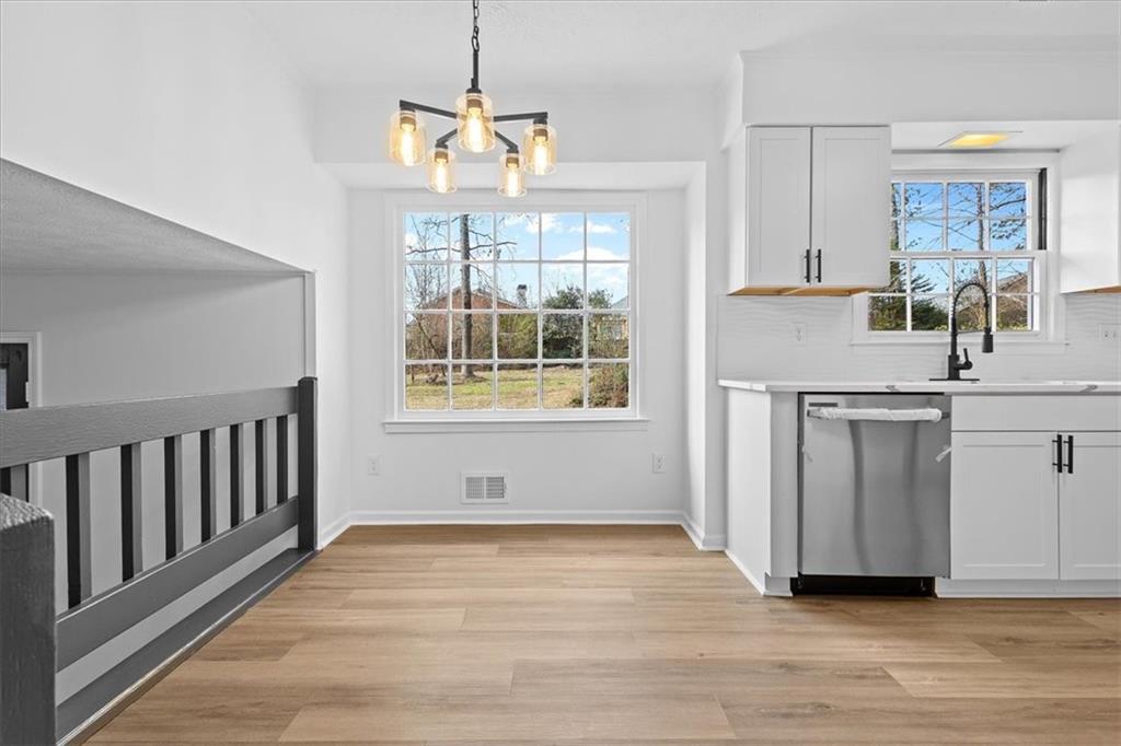 7605 Raleigh Lane Jonesboro, GA 30236 - Photo 26 of 40 a view of a kitchen with wooden floor and a window