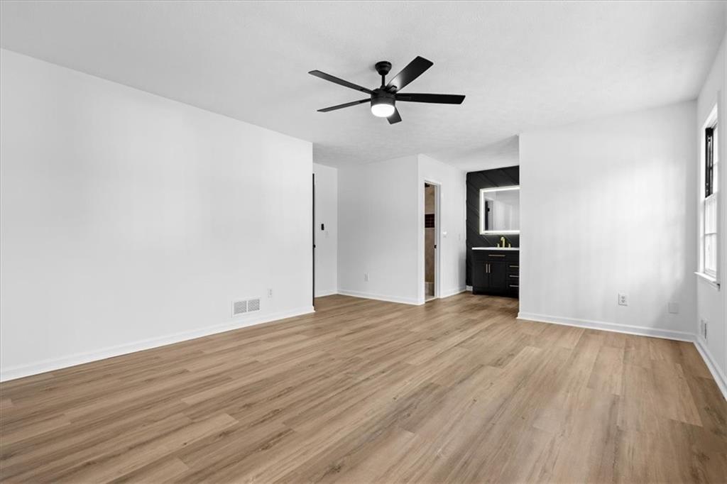 7605 Raleigh Lane Jonesboro, GA 30236 - Photo 28 of 40 a view of empty room with wooden floor and ceiling fan