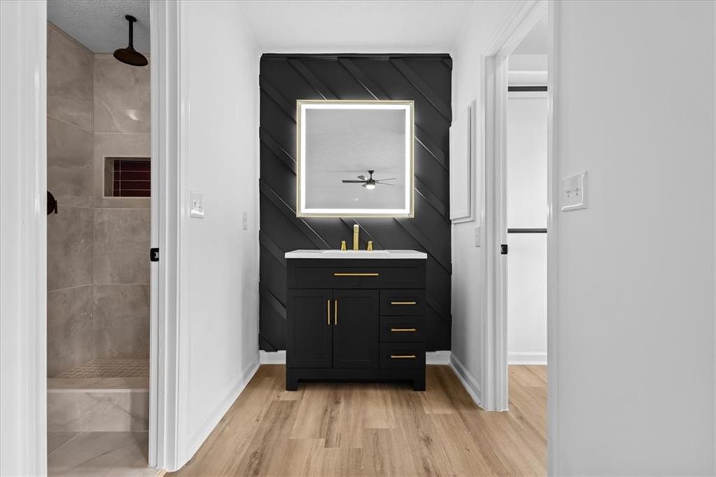 7605 Raleigh Lane Jonesboro, GA 30236 - Photo 29 of 40 a room with a mirror and a wooden floor