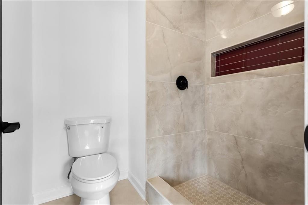 7605 Raleigh Lane Jonesboro, GA 30236 - Photo 30 of 40 a bathroom with a toilet and a shower
