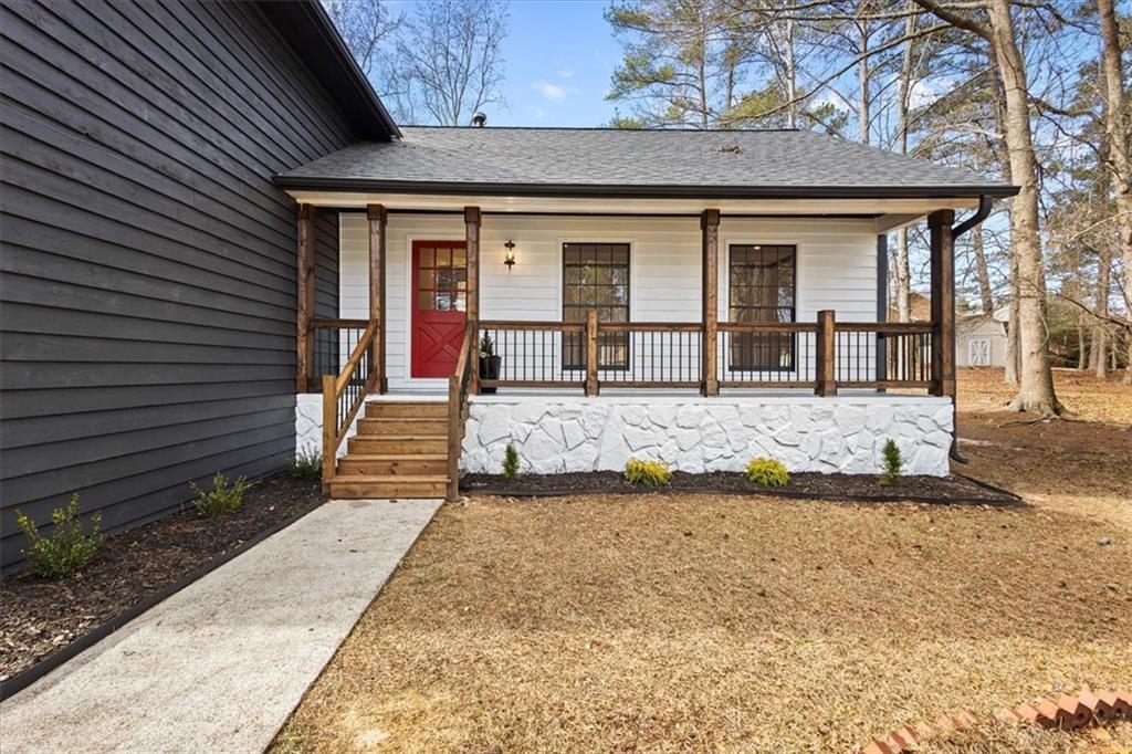7605 Raleigh Lane Jonesboro, GA 30236 - Photo 3 of 40 a front view of a house with a yard outdoor seating and barbeque oven